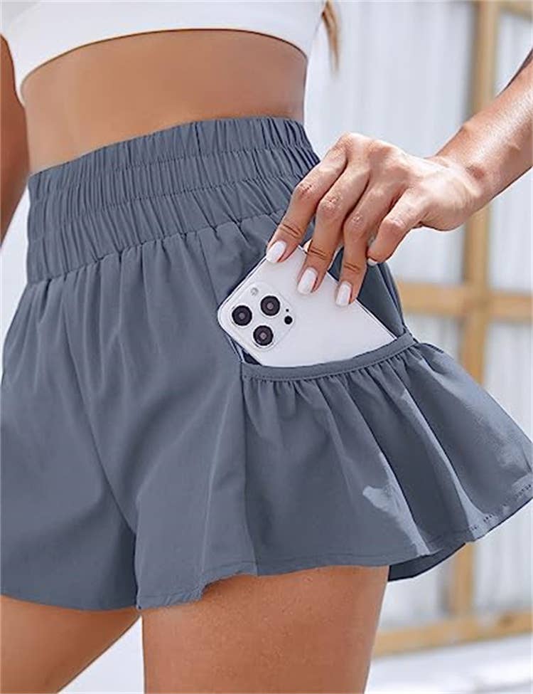 Flowy style high-rise workout shorts with pleated details