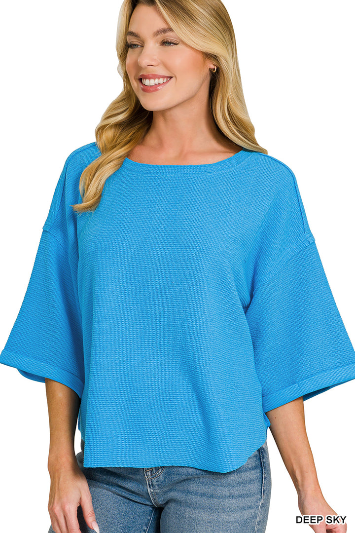Double knit exposed seam curved hem short sleeve top
