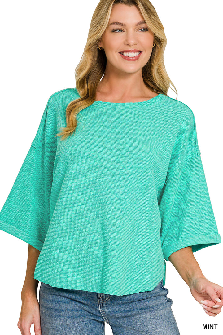 Double knit exposed seam curved hem short sleeve top